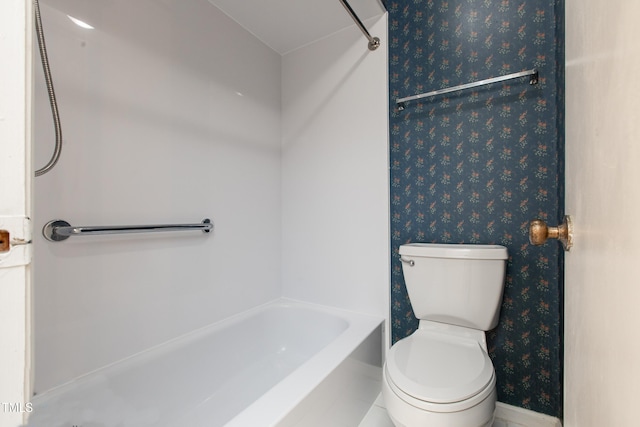 bathroom featuring toilet and shower / tub combination