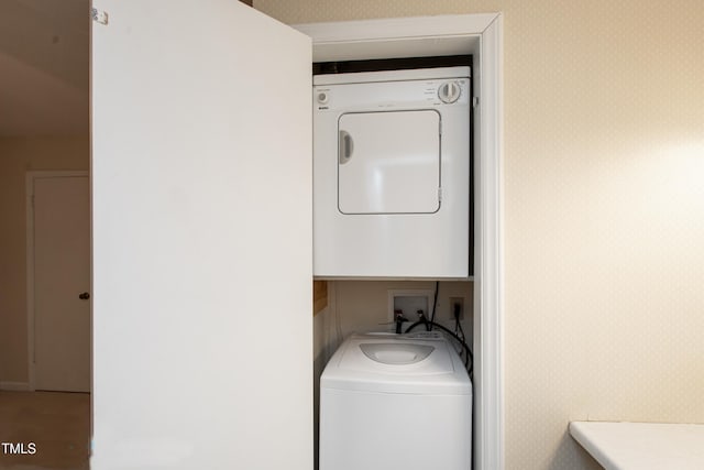 washroom with stacked washer / drying machine