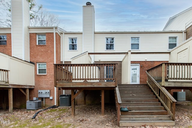 back of property featuring central AC unit and a deck