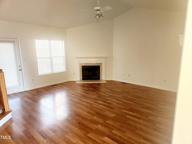 unfurnished living room with ceiling fan, a healthy amount of sunlight, and dark hardwood / wood-style flooring