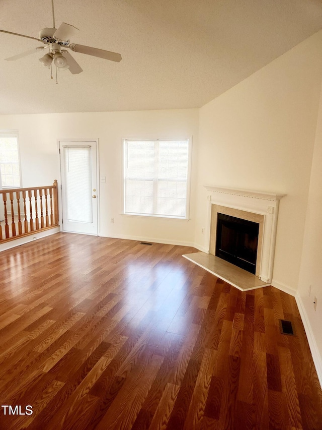 unfurnished living room featuring ceiling fan and dark wood-type flooring