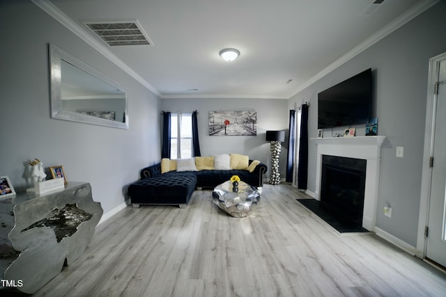 living room with light hardwood / wood-style floors and ornamental molding