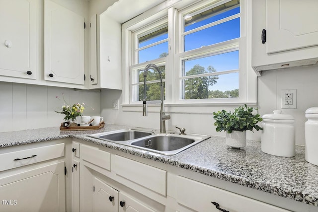 kitchen with sink, white cabinetry, and a wealth of natural light