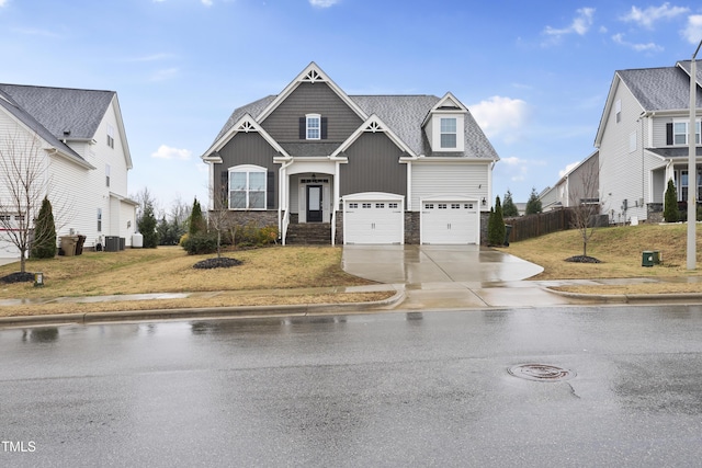 view of front of home featuring cooling unit and a garage