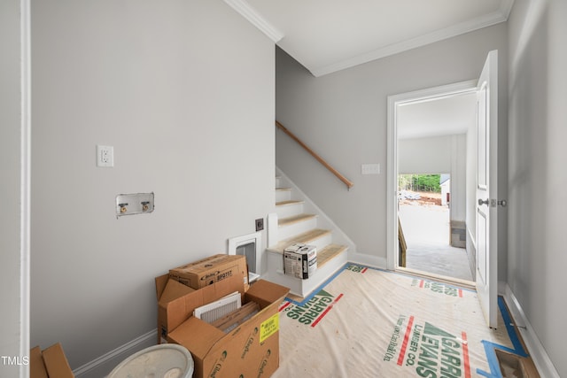 foyer with baseboards, stairway, and crown molding