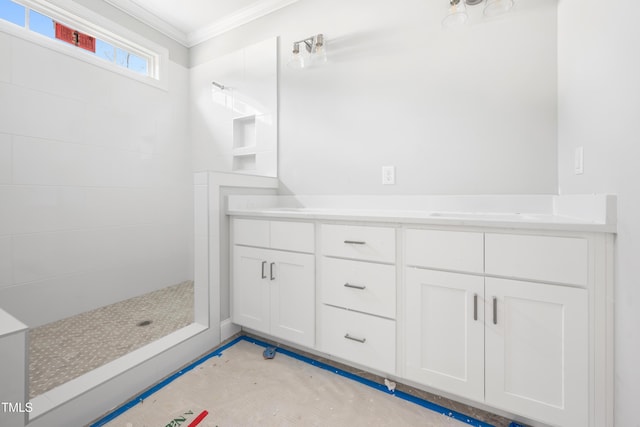 bathroom with walk in shower, vanity, and ornamental molding