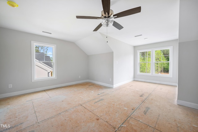 bonus room featuring lofted ceiling, visible vents, baseboards, and ceiling fan