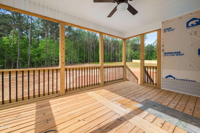 unfurnished sunroom featuring a ceiling fan