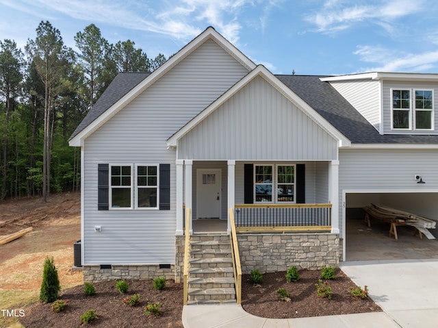 view of front facade featuring cooling unit, crawl space, driveway, covered porch, and roof with shingles