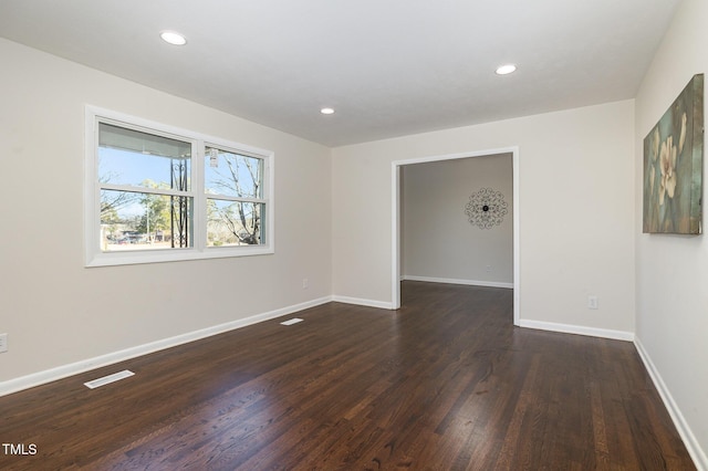 empty room featuring dark hardwood / wood-style flooring