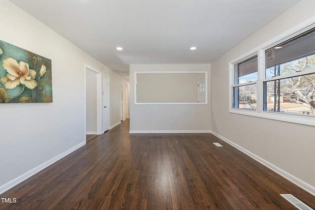 spare room with dark hardwood / wood-style floors