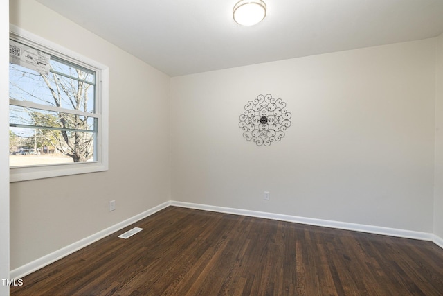 spare room featuring dark hardwood / wood-style flooring