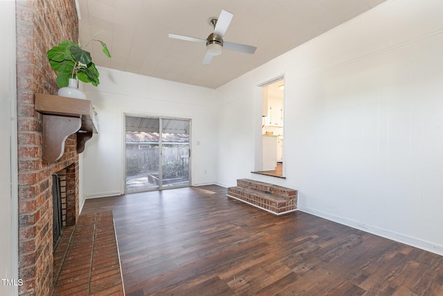 unfurnished living room with a fireplace, dark hardwood / wood-style flooring, and ceiling fan