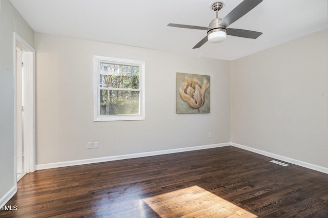 spare room with ceiling fan and dark hardwood / wood-style floors