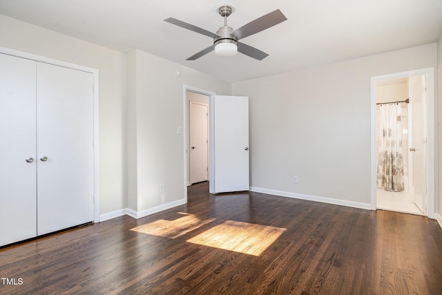 unfurnished bedroom with ensuite bath, ceiling fan, a closet, and dark wood-type flooring