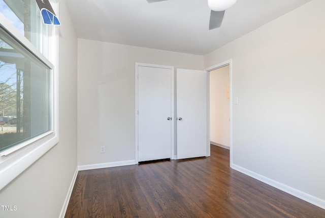 unfurnished bedroom featuring dark hardwood / wood-style floors and ceiling fan