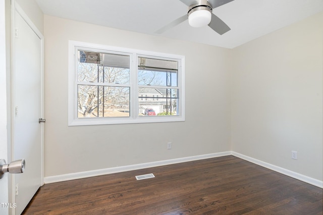 spare room with ceiling fan and dark hardwood / wood-style floors