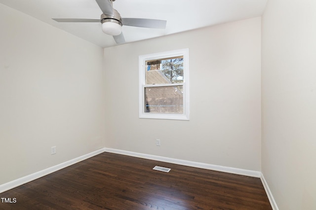 spare room with ceiling fan and dark hardwood / wood-style flooring