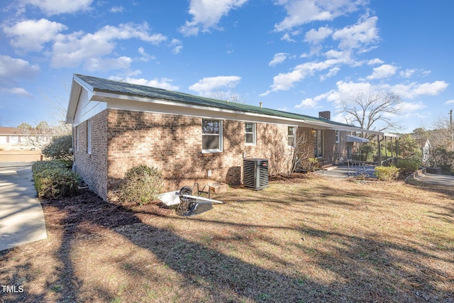 back of property with a patio, cooling unit, and a lawn