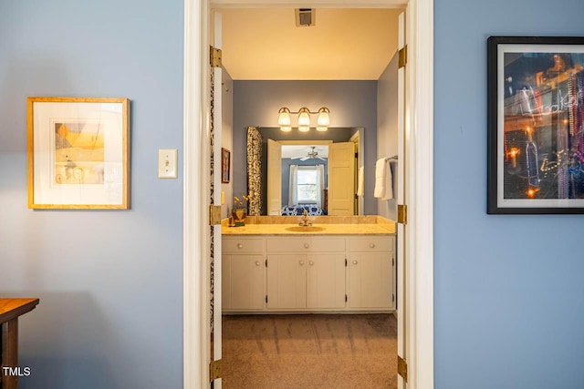 bathroom with ceiling fan and vanity