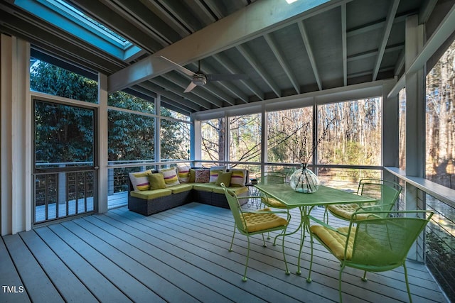 sunroom / solarium featuring lofted ceiling and ceiling fan