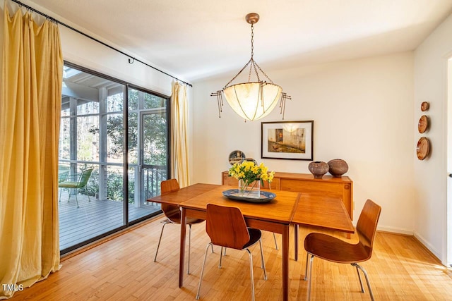 dining space with light wood-type flooring