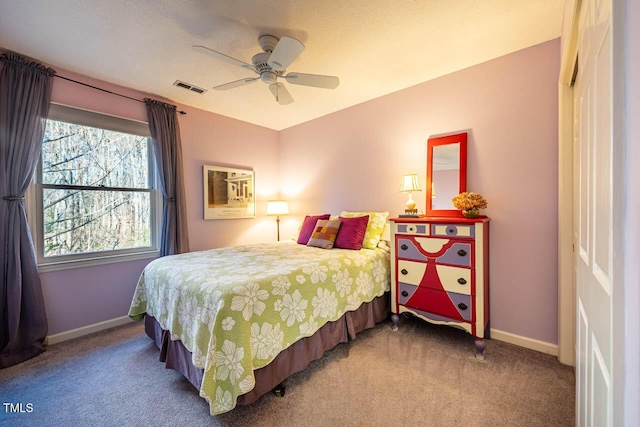 carpeted bedroom with ceiling fan and a closet