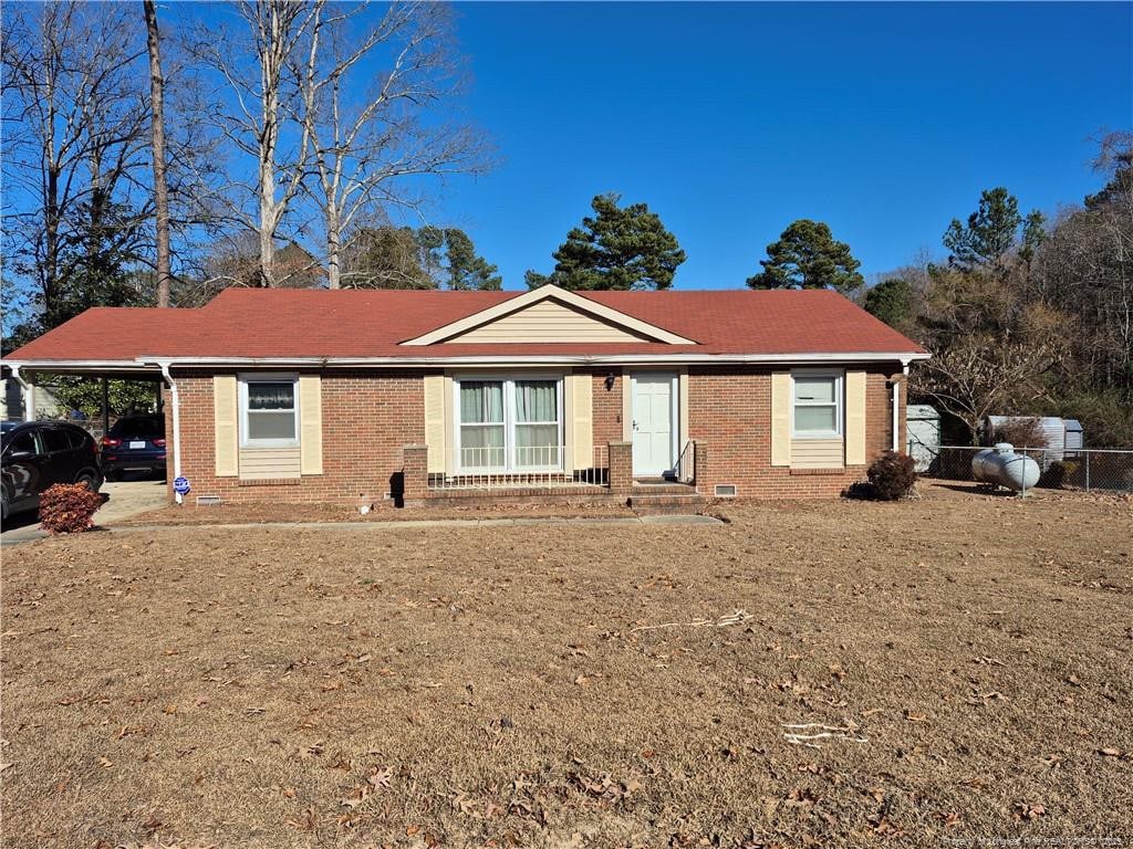 single story home with a carport