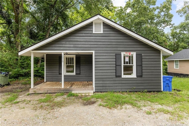 back of house featuring a porch