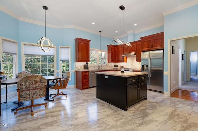 kitchen featuring ornamental molding, stainless steel appliances, a center island, and decorative light fixtures