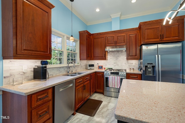 kitchen with light stone counters, decorative light fixtures, exhaust hood, appliances with stainless steel finishes, and sink