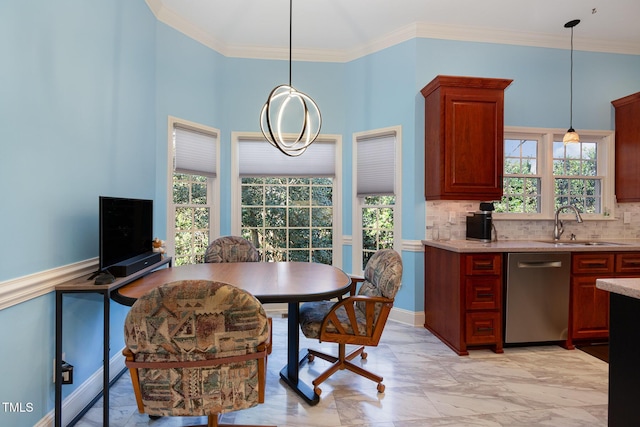 dining room featuring sink, a healthy amount of sunlight, and ornamental molding