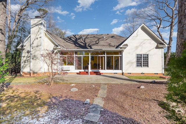 back of property with a patio and a sunroom