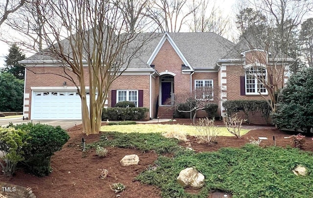 view of front of home with a garage, brick siding, and driveway