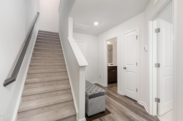 stairs featuring wood-type flooring