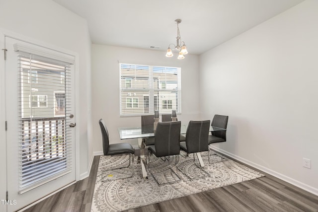 dining room featuring hardwood / wood-style flooring and an inviting chandelier