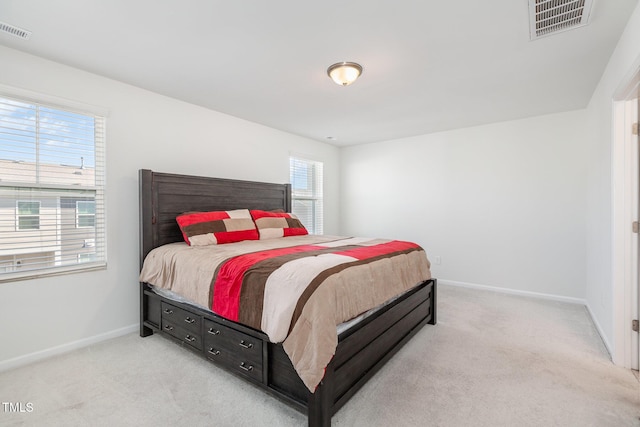 bedroom featuring light carpet