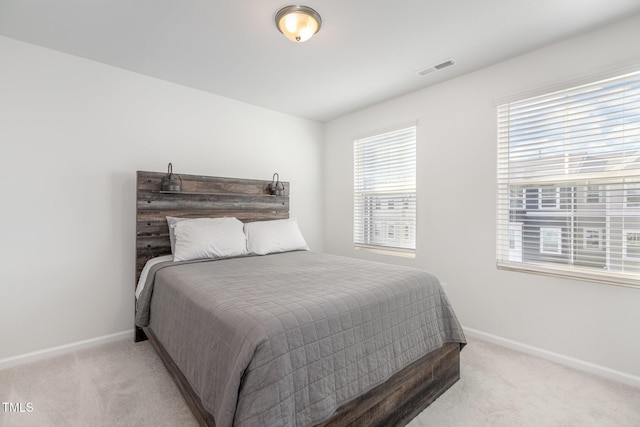 bedroom featuring light colored carpet