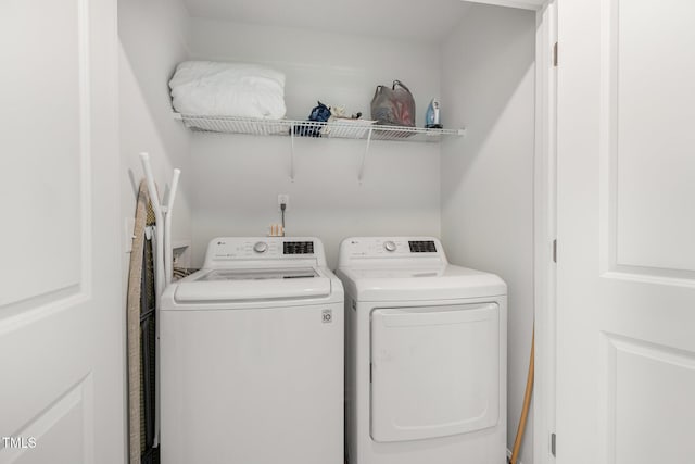 washroom with washer and dryer