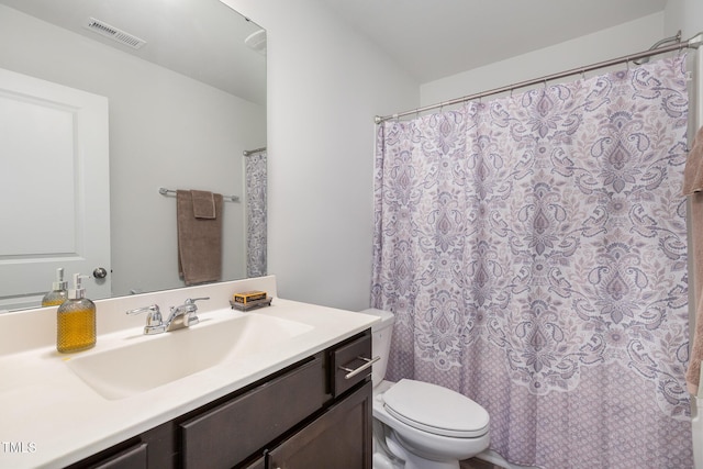 full bathroom with shower / tub combo, vanity, and toilet