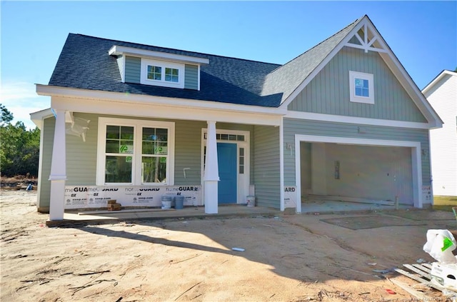 view of front facade featuring a porch and a garage