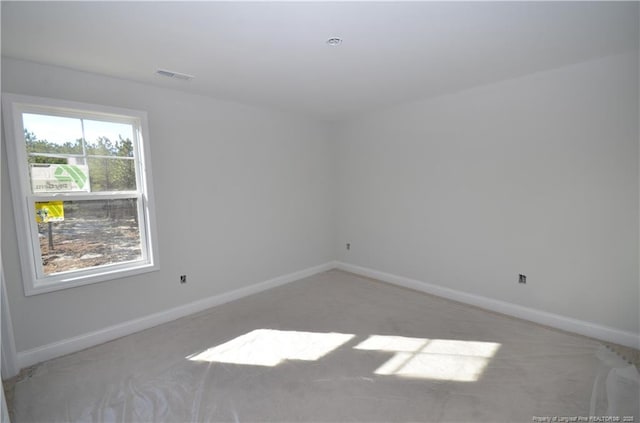 unfurnished room with light carpet