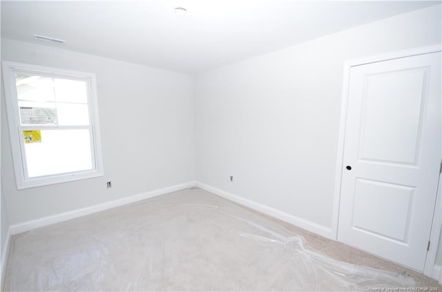 unfurnished room with light carpet