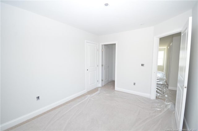 unfurnished bedroom with light colored carpet