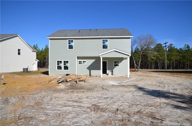 rear view of property featuring central AC unit