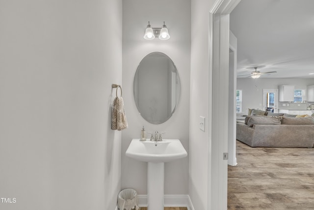 bathroom with ceiling fan, wood-type flooring, and sink