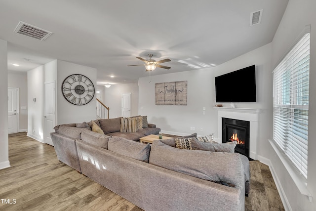 living room featuring ceiling fan and light wood-type flooring