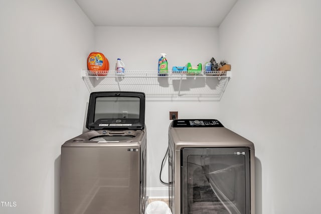 clothes washing area featuring separate washer and dryer