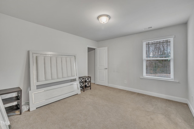 unfurnished bedroom with light colored carpet