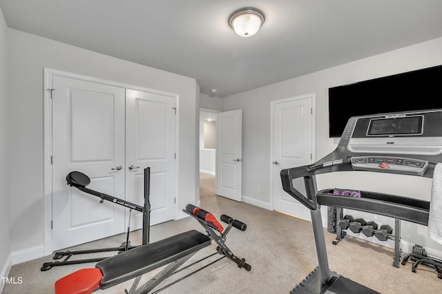 exercise room featuring light carpet